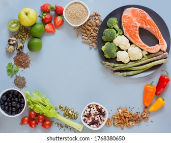 Balanced diet food frame background. Fresh vegatables, fruits, cereals, seeds and nuts on a blue background. Food frame with copy space - Shutterstock ID 1768380650
