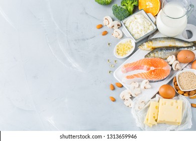 Balanced diet nutrition, healthy eating concept. Assortment of food sources rich in vitamin d and calcium, salmon, dairy products, sardines, broccoli on a kitchen table. Copy space background