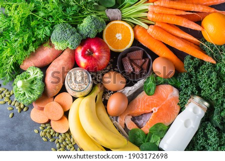 Balanced nutrition concept, asthma and respiratory relieving food, clean eating diet. Assortment of healthy ingredients rich in vitamin d, a, beta-carotene, magnesium for cooking on a kitchen table.