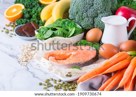 Balanced nutrition concept, asthma and respiratory relieving food, clean eating diet. Assortment of healthy ingredients rich in vitamin d, a, beta-carotene, magnesium for cooking on a kitchen table.