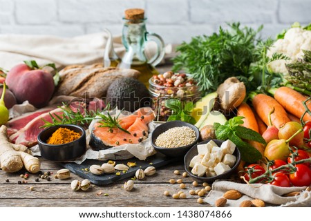 Balanced nutrition concept for clean eating flexitarian mediterranean diet. Assortment of healthy food ingredients for cooking on a wooden kitchen table.
