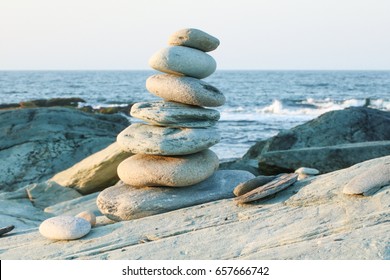 A balanced rock stack in front of the ocean.. Rock balancing is a type of problem solving, and some artists consider it as a skill in awareness and meditation. Patience, serenity, reflection, mindful 
