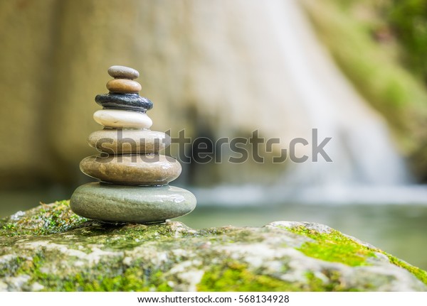 Balanced Rock Zen\
Stack in front of\
waterfall.
