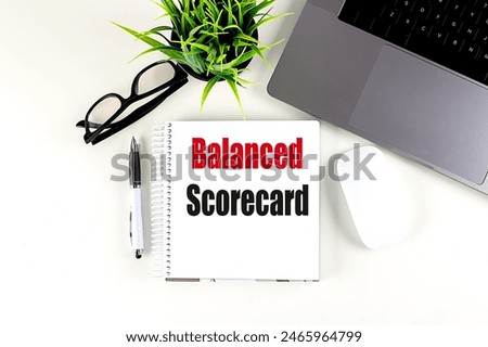 BALANCED SCORECARD text on a notebook with laptop, mouse and pen . 