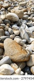 A balanced stack of three smooth river pebbles on a stony background, conveying mindfulness, inner peace, and perfect work-life balance