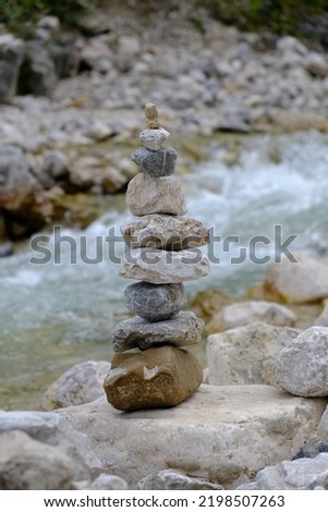 a balanced stone stack by a mountain stream
