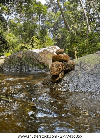 Balanced Stone Stack on River Rock in Tropical Forest Stream