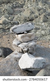 Balanced stone stack on rocky beach shoreline
