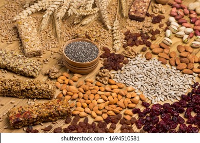 Balanced vegan snack, protein granola bar. Nuts, seeds, cereals, black quinoa, spikelets of wheat. Weight loss concept. Top view. Wooden background. Close up
 - Powered by Shutterstock