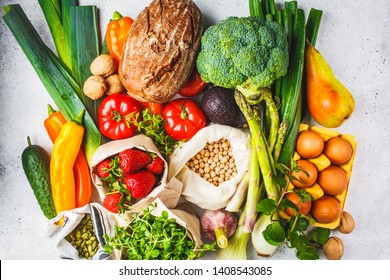 Balanced vegetarian food background. Vegetables, fruits, nuts, sprouts, seeds, chickpeas on a white background, top view.