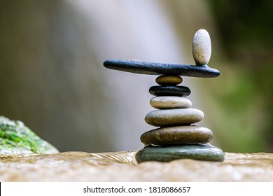 Balanced Zen stones pebbles at the waterfalls - Powered by Shutterstock