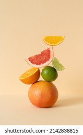 Balancing citrus on the table, copy space. Equilibrium floating food balance. Fruit floats on the table: grapefruit, lime, orange.