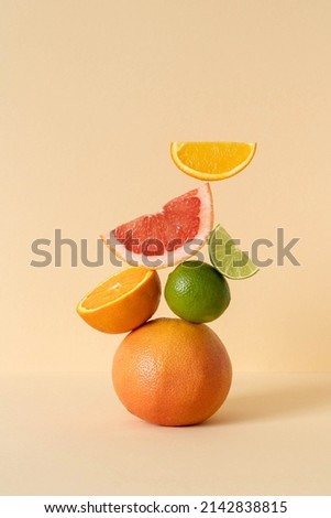 Balancing citrus on the table, copy space. Equilibrium floating food balance. Fruit floats on the table: grapefruit, lime, orange.