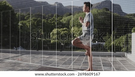 Balancing man holding tree pose wearing fitness tracker on terrace with grid overlay, copy space. Zen, mindfulness, tranquility, digital, wellness, serenity, landscape