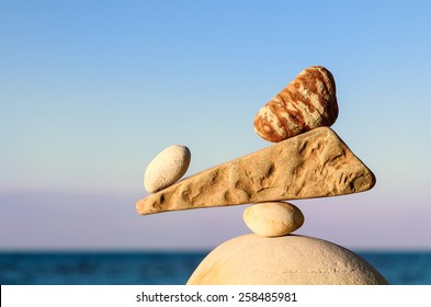 Balancing of pebble between stones on the seashore - Shutterstock ID 258485981