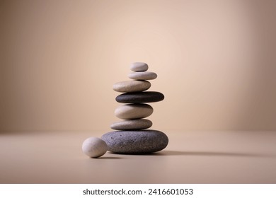 Balancing pebble stones on beige background. Relax, meditation and zen concept. - Powered by Shutterstock