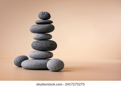 Balancing pebble stones on beige background. Relax, meditation and zen concept. - Powered by Shutterstock