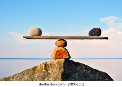Balancing of pebbles on the top of stone - Shutterstock ID 238352332