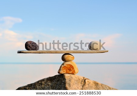Balancing of pebbles on the top of stone