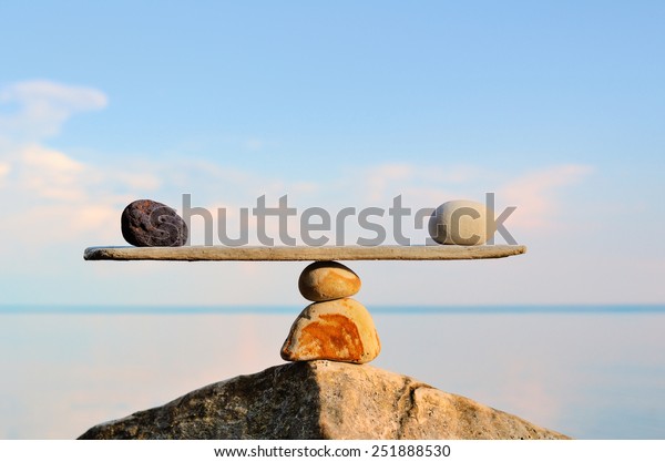 Balancing of pebbles on the top of stone