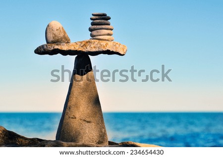 Balancing of pebbles on the top of triangle stone