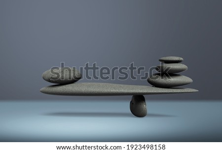 Balancing pyramid of sea pebbles on a gray desk, the concept of harmony and balance,