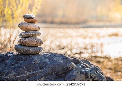 Balancing stone on shore. Balance of scales. Harmony in decision making Balanced stones on top of boulder. Peace of mind balance for meditation. - Shutterstock ID 2142989691
