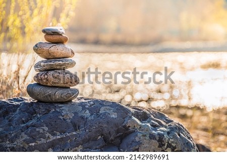 Balancing stone on shore. Balance of scales. Harmony in decision making Balanced stones on top of boulder. Peace of mind balance for meditation.