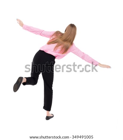 Balancing young business woman.  or dodge falling woman. Rear view people collection.  backside view of person.  Isolated over white background. girl office worker in black trousers jumping on one leg