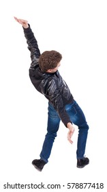 Balancing Young Man Or Dodge Falling Man. Rear View People Collection.  Backside View Of Person.  Isolated Over White Background. The Guy In The Leather Jacket Falls On His Back.