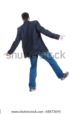 Balancing young man in jacket. Rear view. Isolated over white.