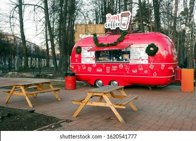 Balashikha, Russia - January 18, 2020. Bam Coffee kiosk and wooden tables for customers at the entrance into Pekhorka park.
