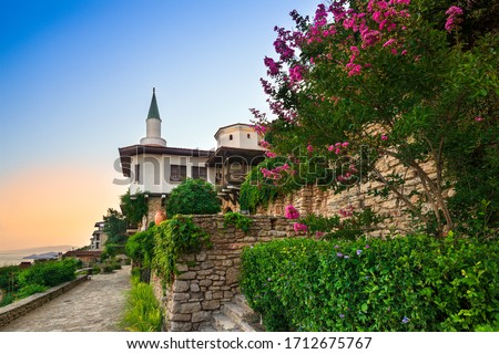 Balchik, Bulgaria / 06.08.2017: Balchik Palace Castle of Romanian Queen Marie at Bulgarian Black Sea coast. Beautiful romantic garden with colorful flowers.