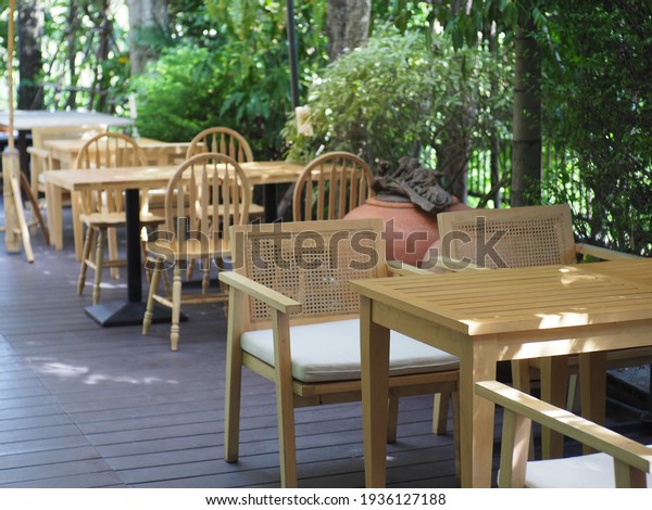 Balcony chairs\
in the back set with green\
plants