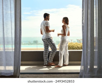 Balcony, coffee and morning with couple in hotel room together for holiday, travel or vacation. Love, summer or view with happy man and woman in luxury apartment for anniversary, honeymoon or bonding - Powered by Shutterstock