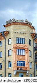 Balcony With Columns On Facade Of Old Residential Building Decorated With Bas-reliefs. Stalinist Architecture, Stalin Empire Style. Balcony And Windows Of Soviet Building
