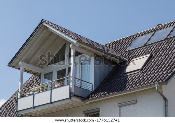 balcony with\
gable roof on residential\
building