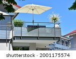 Balcony with Handrails of high-grade Steel and high-grade Steel privacy protection Screen at the Front of a modern residential Building