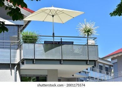 Balcony with Handrails of high-grade Steel and high-grade Steel privacy protection Screen at the Front of a modern residential Building