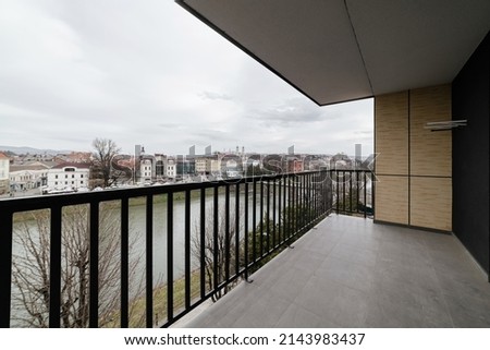 balcony with metal black railings. city view