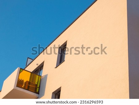 Balcony with a partition made of bright, colored glass. Modern architecture details