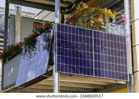 Balcony Solar Panels. Mini photovoltaic power plant. Solar battery on balcony wall of modern house in Germany.  Mini PV plants generate your own electricity plug play.