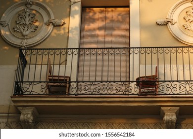 Balcony Of A Spanish House, Two Chairs Opposite Each Other;
Sunset