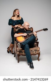 Bald Bearded Man Plays The Guitar. The Woman Sings A Song. Acoustic Duet.