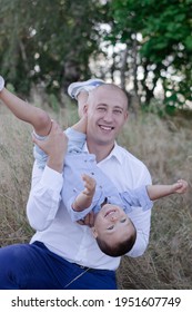 Bald Dad And Little Son In The Field Or Forest On Sunny Summer Day. Father's Day.