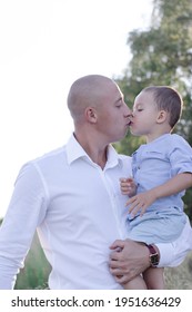 Bald Dad And Little Son In The Field Or Forest On Sunny Summer Day. Father's Day.