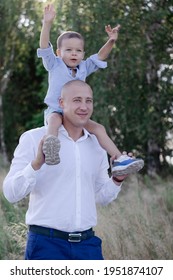 Bald Dad And Little Son In The Field Or Forest On Sunny Summer Day. Father's Day.