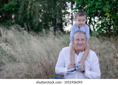 Bald Dad And Little Son In The Field Or Forest On Sunny Summer Day. Father's Day.