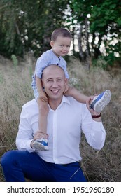 Bald Dad And Little Son In The Field Or Forest On Sunny Summer Day. Father's Day.