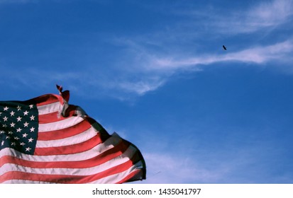 A bald eagle flying high over the American Flag.  The ultimate symbol of the American Independence Day; this is not 2 seperate images.